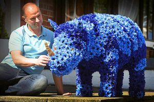 Florist Paul Mincher with the life size baby rhino, he has made out of flowers