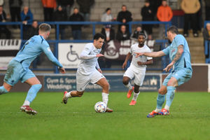 AFC Telford United midfielder Charlie Williams runs between two Southport players