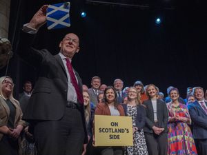 John Swinney taking a selfie of himself and dozens of people on stage