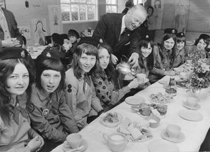 Llandysilio Girl Guides, April 19, 1972. The caption reads: 'Mr G.W. Jeffreys, chairman of the parish council, pours tea to the eight guides of Swallow patrol from Llandysilio, Four Crosses, near Oswestry, (who) have won a fortnight's holiday in Mexico. From left, Pauline May, Heather Ellis, Pat Jones, Amanda Lloyd, Heather Passant, Gail Griffin, Christine May, and Pam Walker. They returned to the village yesterday and were given a tea by the council.'