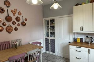 The kitchen has integrated appliances and plenty of workspace