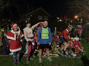 Taking a moment at Boughey Corner's Christmas display are, from left: Lisa Yap, Lexy Tapley, John Metzger and Simon Yap