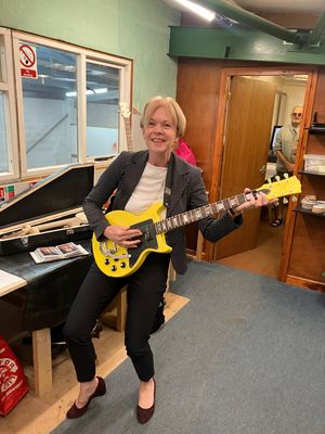 Wendy Morton MP at Aldridge Shed - trying out a guitar that was made from scratch by one of the members