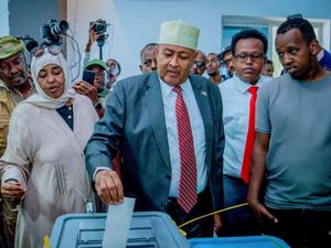 Abdirahman Mohamed Abdullahi, centre, casts his vote inside a polling station in Somaliland