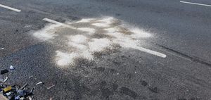 An area of the road had a covering over what might have been oil or fuel