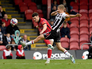 Connor Barrett will start his two-match suspension at Gillingham on Saturday.