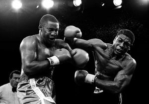 Frank Bruno throws a shot at Tim Witherspoon in their world title fight 30 years ago to this day.