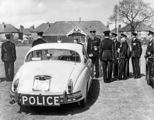 HM Inspector of Constabulary Sir Charles Martin was pictured talking with the driver of one of the new Jaguar cars used for patrols on the M6 when this picture was taken at the county police headquarters at Stafford in May, 1962. 