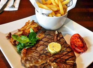 Love at first bite - the 14oz T-bone steak with parsley butter, seasoned fries, onion bread and grilled tomato