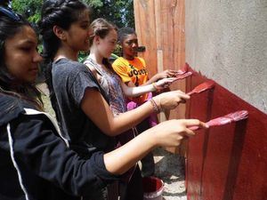 The youngsters add a lick of paint.