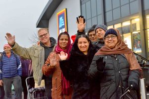 Happy shoppers ready to go inside