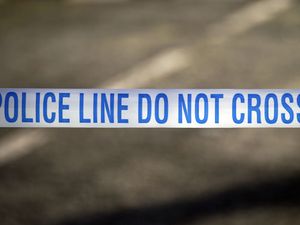 Police tape near the scene of a suspected crime