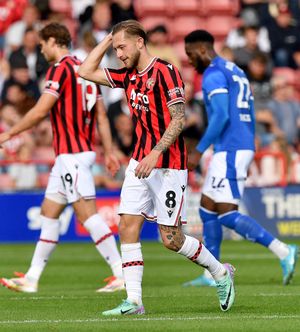 Charlie Lakin makes his way off the pitch after getting a red card for a second bookable offence.