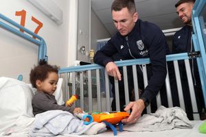 West Bromwich Albion F.C. captain Jed Wallace with a young patient at the Midland Met