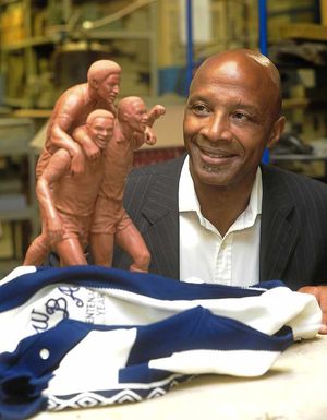 Regis with a model of the statue