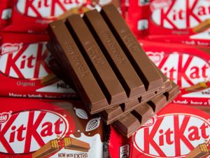 Four-finger KitKat biscuits, lying on top of several unopened packs