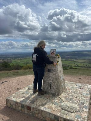 Leanne Vaughan places a picture of her daughter Lily-May at the top of the Wrekin