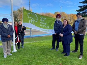 Supporting image for story: Group marks double celebration with raised flag