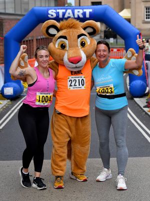 Earl Edwards with Jo Catson and  Francesca Hutcheson celebrate finishing their run