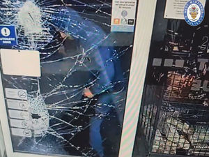 Supporting image for story: The shocking moment a Stourbridge chocolate thief smashes through a shop window with shovel to steal confectionery