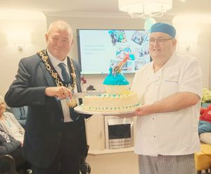 Mayor of Tamworth, Councillor Chris Bain, cuts Arkall Manor's Birthday Cake