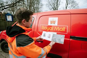 Postman Dave Hart was surprised with a Thank You book for his efforts to put a smile on his local community's face