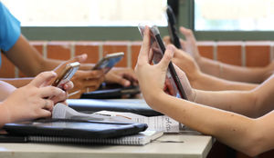 Students on phones at school table