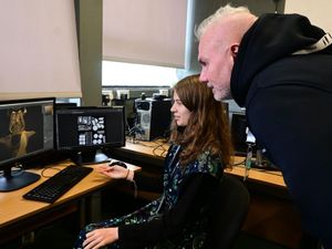 Gaming student Stephanie Thompson shows her work to Trev Keane, co-founder and managing director at Feenix Group