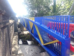 The Meole footbridge - and its blue and amber paint job - was lifted into place over the weekend.