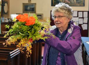 Linda Watt with her flower arrangement. photo Eddie Brown