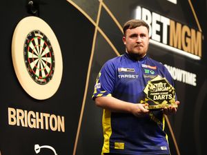 Luke Littler poses with the trophy after victory in the final during night five of the 2025 Premier League at the Brighton Centre