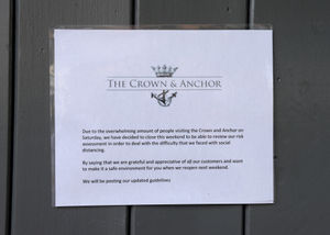 A sign on the door of the Crown and Anchor pub states it was closing last weekend