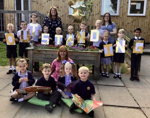 Pupils celebrate their Ofsted report with executive head Shelley Reeves-Walters (left), head of school Charlotte McDonald (right) and longest serving teacher Sharon Mason, head of early years, retiring this summer after 24 years