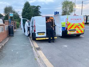 Police and forensic teams outside a house in St Martins