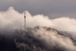 A brief break in the clouds reveals the Wrekin mast and beacon during snowfall. Photo: Mike Sheridan