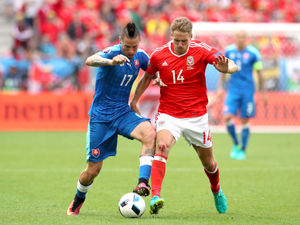 Supporting image for story: Shrewsbury Town midfielder Dave Edwards auctioning Wales shirt