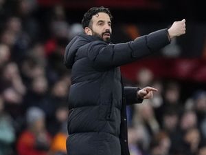 Manchester United manager Ruben Amorim waves from the touchline