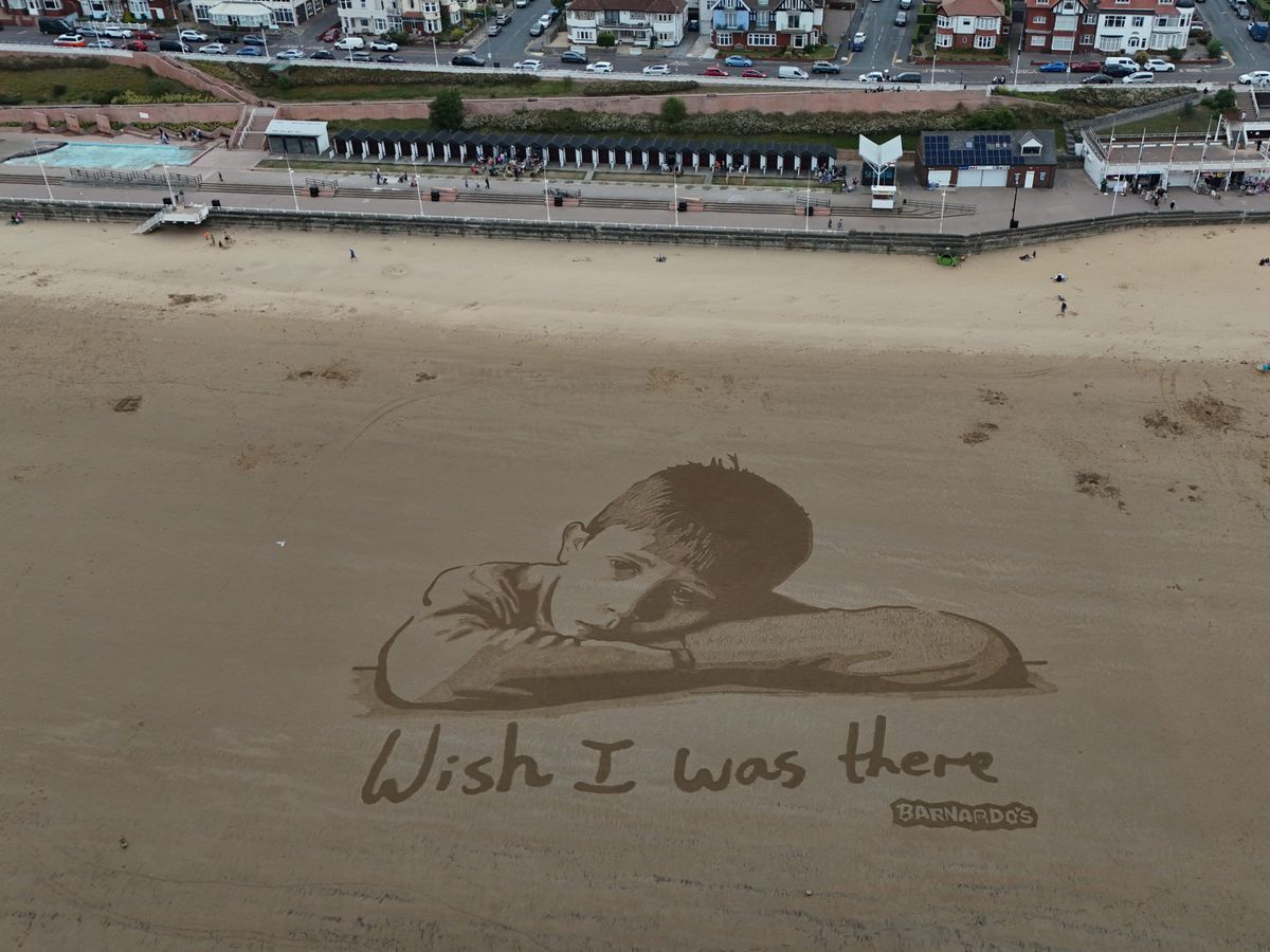 Huge sand artwork highlights how child poverty means millions miss out in summer Huge sand artwork highlights how child poverty means millions miss out in summer