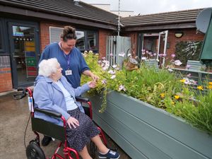 Residents and staff enjoy exploring the garden together.