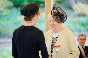 June Beharrell beams as she collects her British Empire Medal