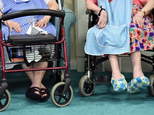 Ladies' feet resting on a wheelchair in a care home