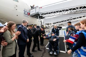 Veterans disembarking from ramp.