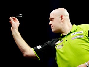 Michael van Gerwen in action (David Davies/PA)