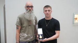 Toby Williams (right) with Dauvit Alexander, a Senior Lecturer at the School of Jewellery at BCU, who organised the medal competition and oversaw the design work with Toby