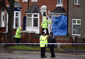 Police at the house in Pensnett Road where the violence started
