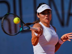Britain’s Emma Raducanu returns the ball
