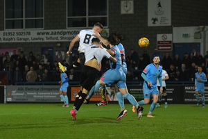 Jordan Piggott (AFC Telford United Defender) gets his head on the ball to direct it just wide of the goal (pic Kieren Griffin)