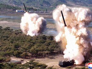 Photo provided by the North Korean government showing what it says a drill of long-range artillery and missile systems at North Korea’s eastern coast