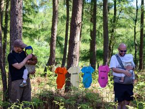 Supporting image for story: Dads challenge Britain's 'rubbish' paternity leave policy by hanging babygrows in Cannock Chase Forest