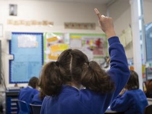 Child raises hand in class
